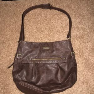 Woman’s brown Roxy purse